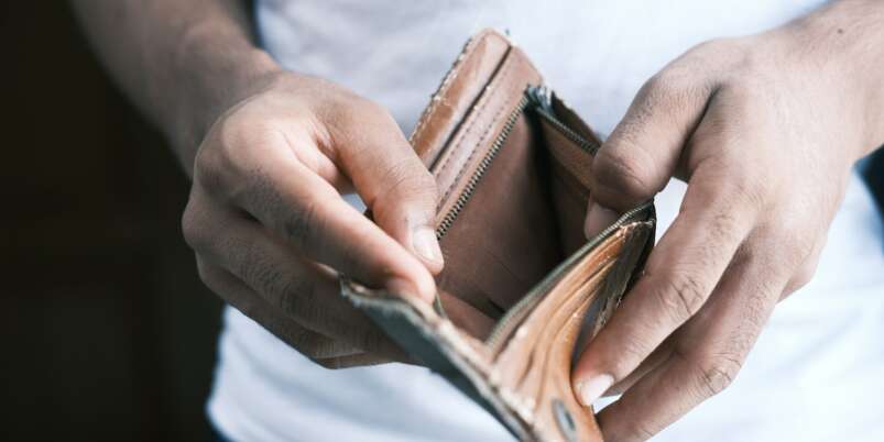 person holding brown leather bifold wallet